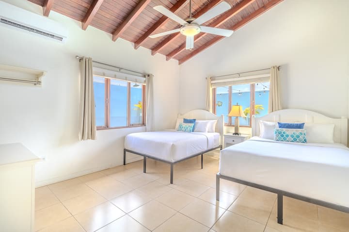Bedroom 3 | Sink into the comfort of not one, but two queen-size beds, ensuring ample space for a rejuvenating night's sleep. Entertainment awaits with a convenient TV setup, making it the ideal spot for unwinding after a day of adventure