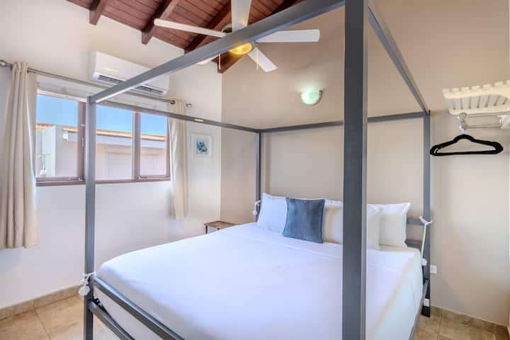 Bedroom 4 | Enjoy the spacious luxury of a king-size bed, complemented by modern amenities including a TV for your entertainment needs. Experience tranquility and rest in this elegant retreat.