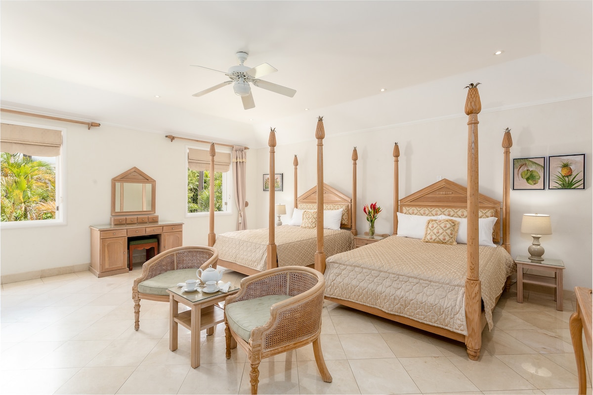 Bedroom 4 with en suite and garden view. This room has twin beds, TV plenty of  clothes storage within its walk in wardrobe and a filtered walk in shower.