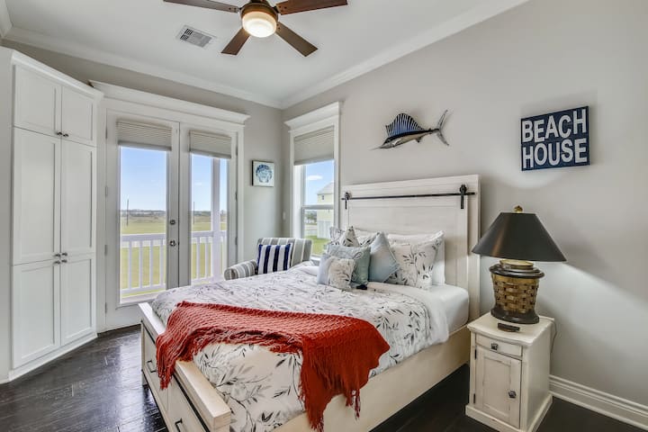 Main-floor queen bedroom with access to the deck which offers a view of the neighborhood.