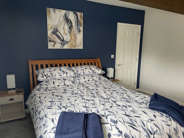 The Master bedroom enjoys a spacious en suite shower room with basin, heated towel radiator, toilet and shaving point. 
There is plenty of storage space including a wardrobe. Shelves contain a range of books.