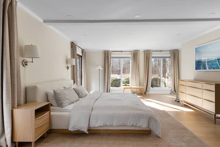 Habitación bañada por el sol con cama tamaño king/colchón de aguacate. También tiene dos vestidores para almacenamiento.