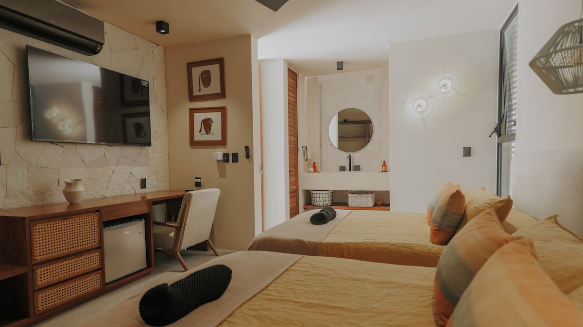 Relish in spacious comfort in Bedroom 2, where two queen-sized beds await your indulgence, accompanied by a private bathroom for added convenience and luxury during your stay.