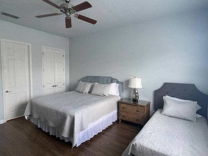 Spacious second floor bedroom with 55 inch TV with king, twin bunk and twin beds.