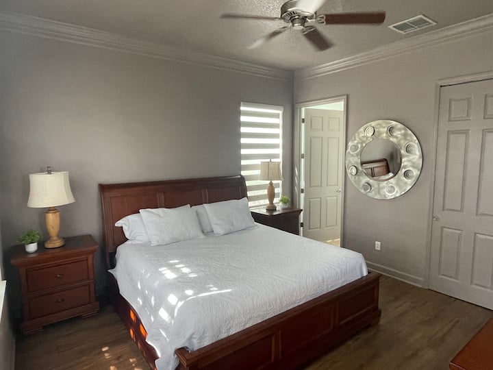 Spacious first floor master bedroom with king bed, 45 inch TV, and private attached master bathroom.