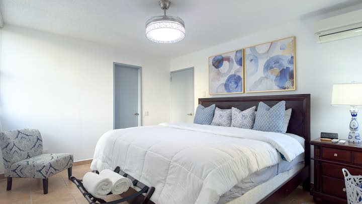 The master bedroom comfortably sleeps up to two guests in a dreamy king-size bed. 