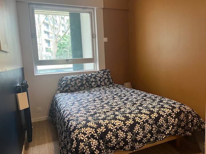 מיטת חדר שינה קטנה, 2 אנשים המשקיפים על הגינה 