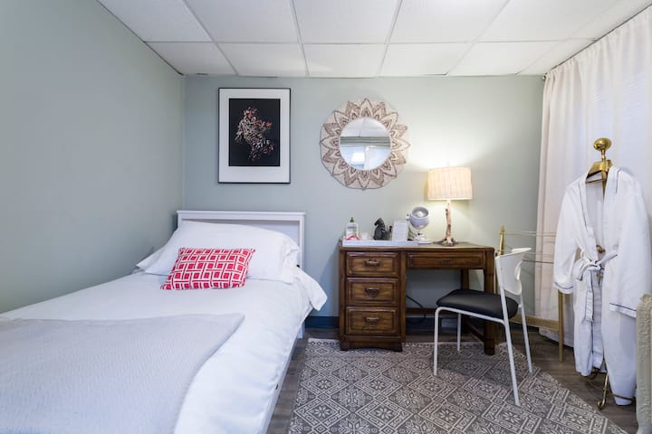 Twin sized bed in private bedroom.