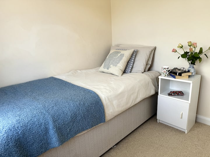 Bedroom Three with a twin bed and bedside table.