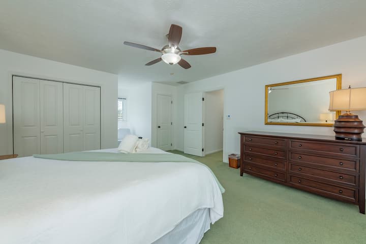 Another view of the bedroom's cozy queen-size bed and spacious closet area.