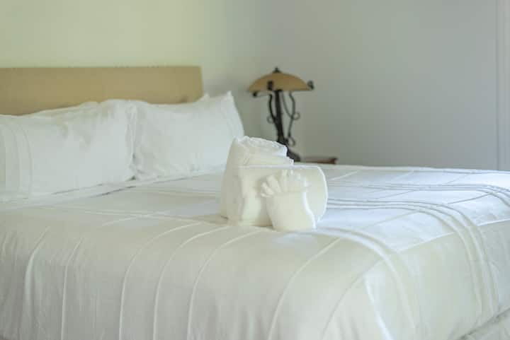 Another view of the cozy king-size bed in the master bedroom.