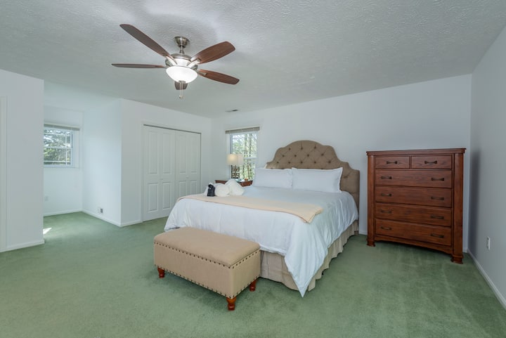 Relax in this bedroom located on the second floor, featuring a spacious king-size bed.
