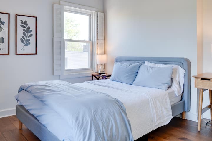 The main bedroom features a queen size bed with amazing light and luxury linens