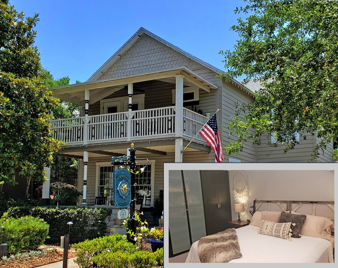 The exterior of a charming house features a welcoming porch with rocking chairs and an American flag. A spacious bedroom is visible, showcasing a neatly made bed adorned with decorative pillows and a textured blanket. Large windows allow natural light to fill the room.
