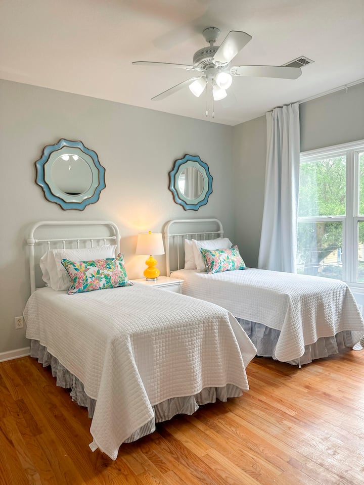 Two cozy twin beds await your arrival.  Each bed is adorned with fluffy pillows, promising a restful night's sleep after a day of adventure on Tybee Island.
