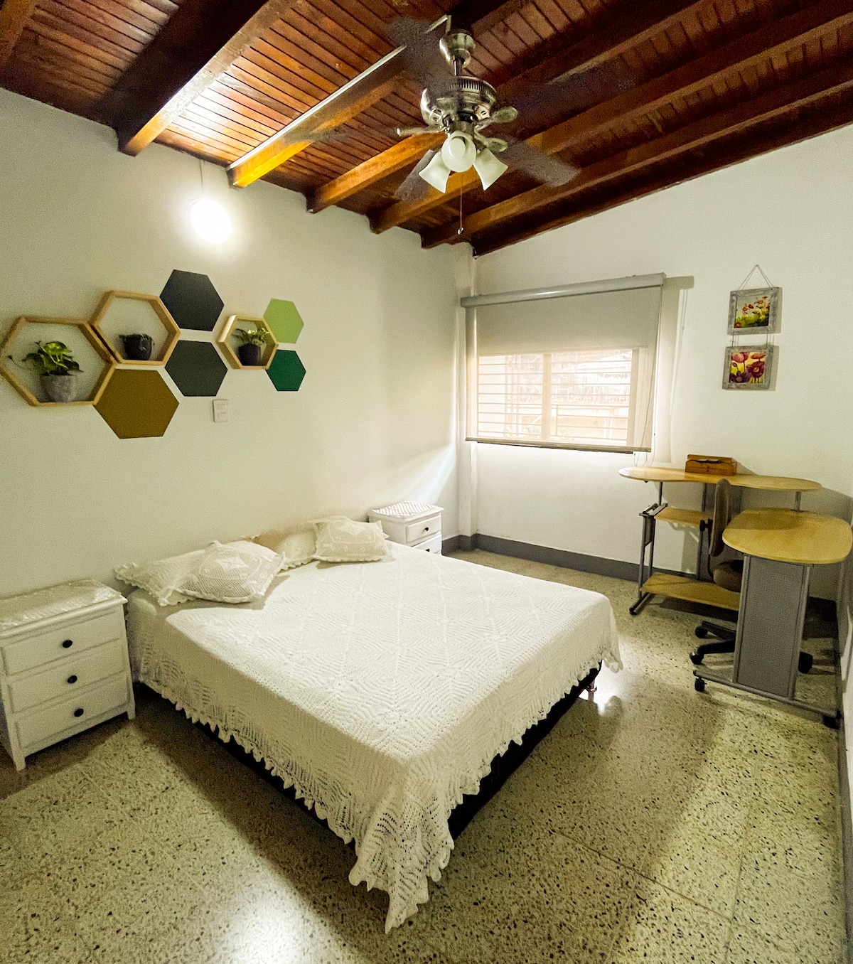 Стая №2, голямо легло, две странични маси, килер, килер, маса за обучение, маса за обучение, прозорец, прозорец, вентилатор на тавана и декор, който определя помещението