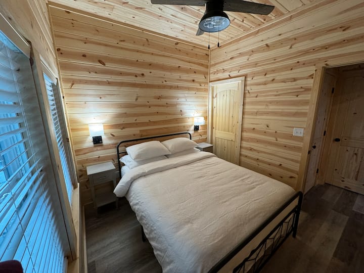 Queen size bed in first floor bedroom.