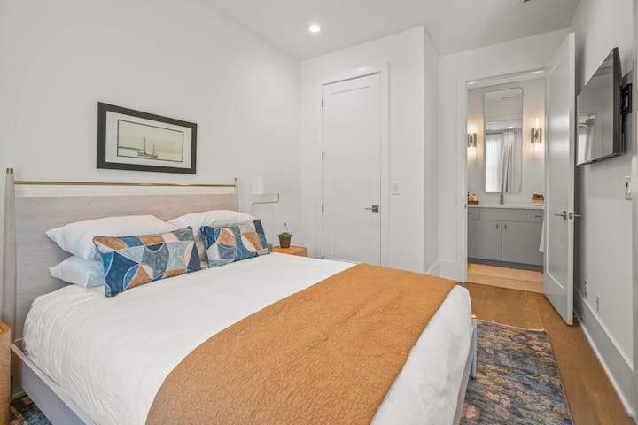 Second bedroom with queen bed and ensuite full bathroom on top floor.