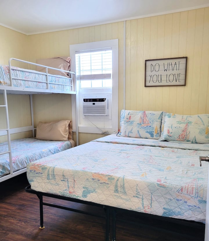 The bedroom has a queen bed and a set of bunk beds.  There is air conditioning in each room.