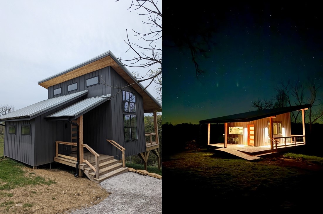 The exterior of a modern cabin is revealed, featuring a sleek metal facade and large windows. A set of wooden steps leads to the entrance, while a ramp provides accessibility. The cabin is illuminated softly at night, showcasing its welcoming entryway and surrounding natural landscape.
