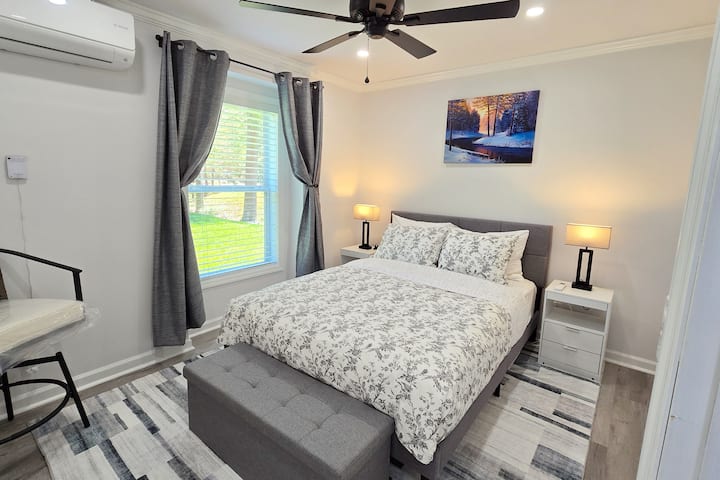 Second bedroom with a queen bed, large window and big closet.