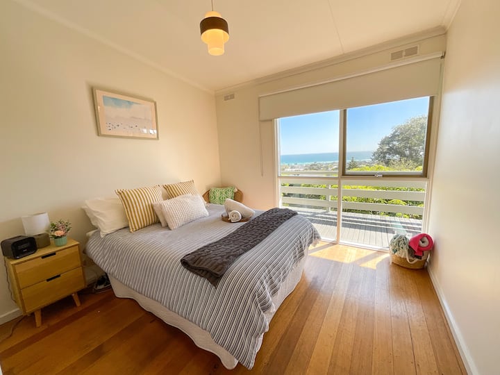 Bedroom 2 has a double bed with a walk in robe with lots of room to put away clothes and luggage.  Wake up to the amazing views of the bay.