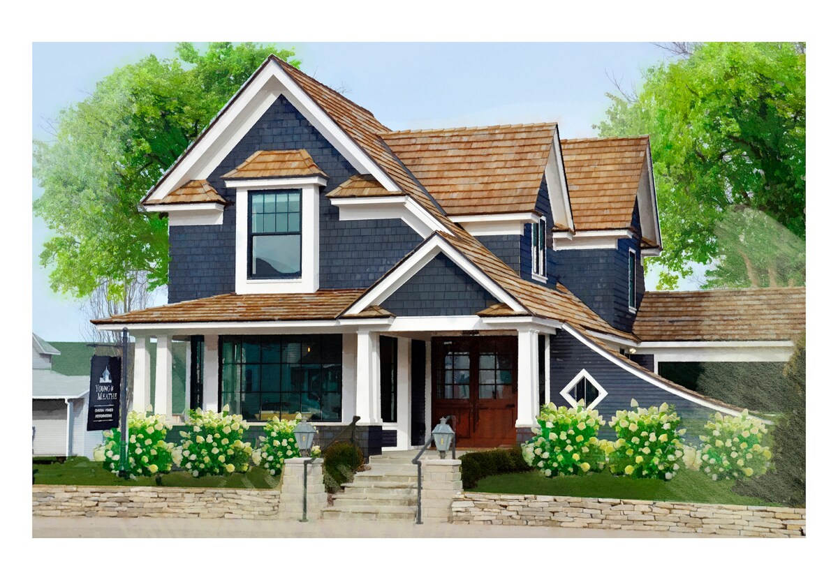 A charming two-story home features a distinctive dark exterior with white trim. The front porch is adorned with welcoming flower beds and a mix of greenery. Large windows invite natural light, while the unique roofline adds character to the overall design.