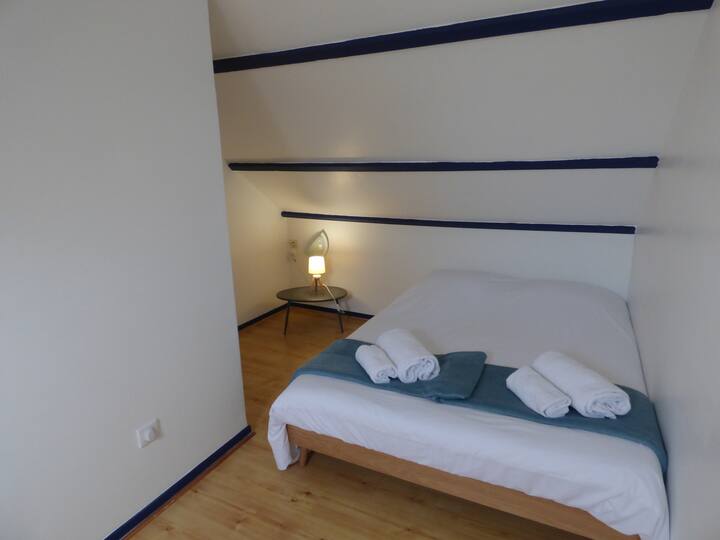 Habitación de arriba abuhardillada con cama de matrimonio y cama individual