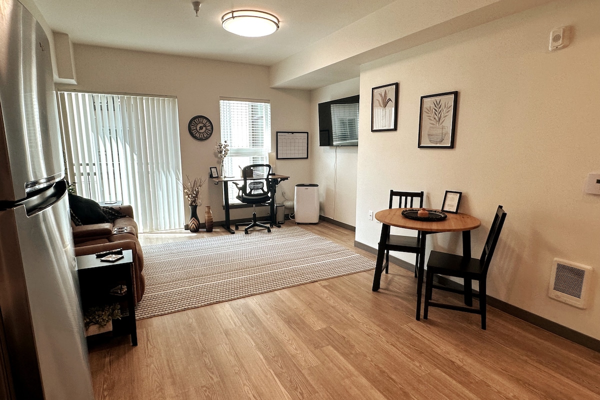 Cozy dining area for two with a dedicated workspace and comfortable living space nearby