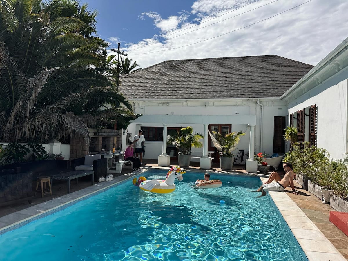 The swimming pool and courtyard at Utopia co-living mansion in Fresnaye, Cape Town