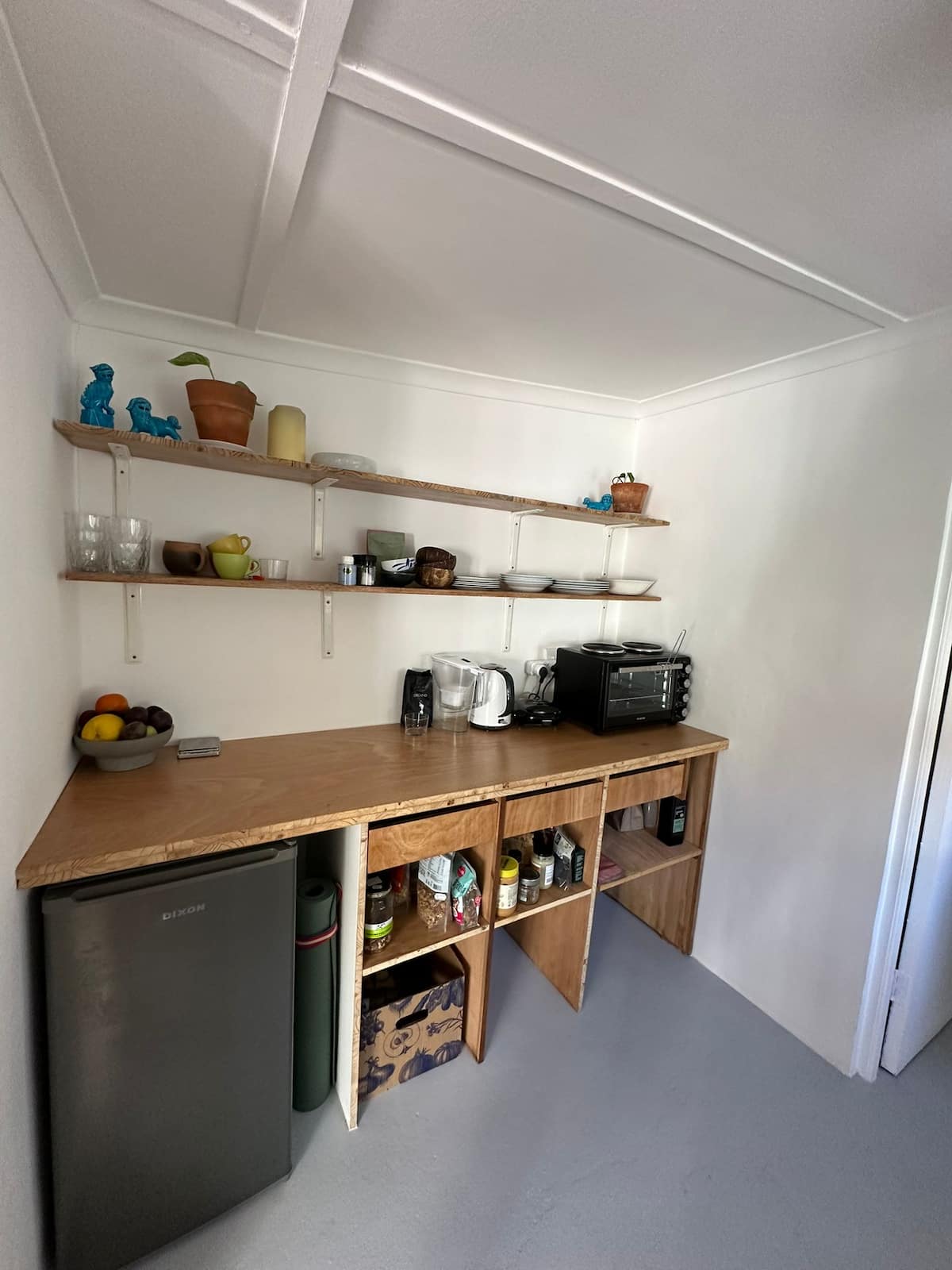 Communal kitchen shelves at Utopia co-living space, Atlantic Seaboard