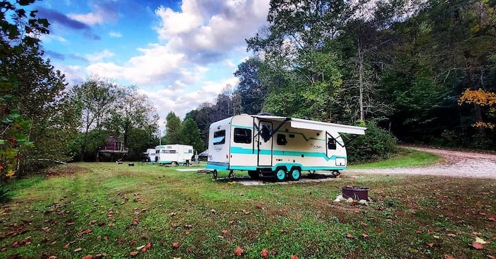 Our Vintage Vagabond camper is small, but mighty. Queen bed, heat, AC, radio/CD player, microwave, fridge/freezer, 2 sinks, coffee maker, dishes/utensils, couch, and dining area. Outside, there is a firepit and view of the creek.