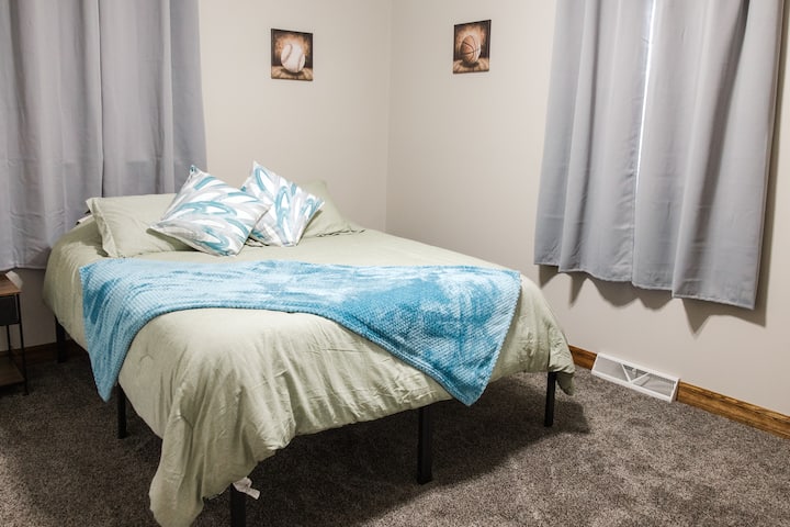 Queen bed with smart TV, night stands, alarm clock w/sound machine, closet w/ hangers, dresser & room darkening curtains.
