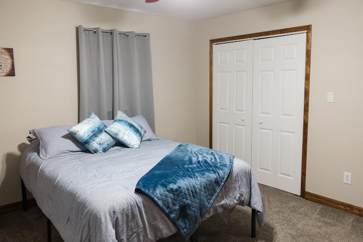 Queen bed with smart TV, night stands, alarm clock w/sound machine, closet w/ hangers, dresser, room darkening curtains & back deck access.