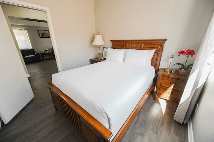 Dormitorio con cabecera de madera y vista al pasillo