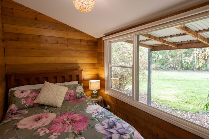 This cosy bedroom overlooks the front of the property and is located downstairs off the main living area and captures the warmth of the fireplace effectively.