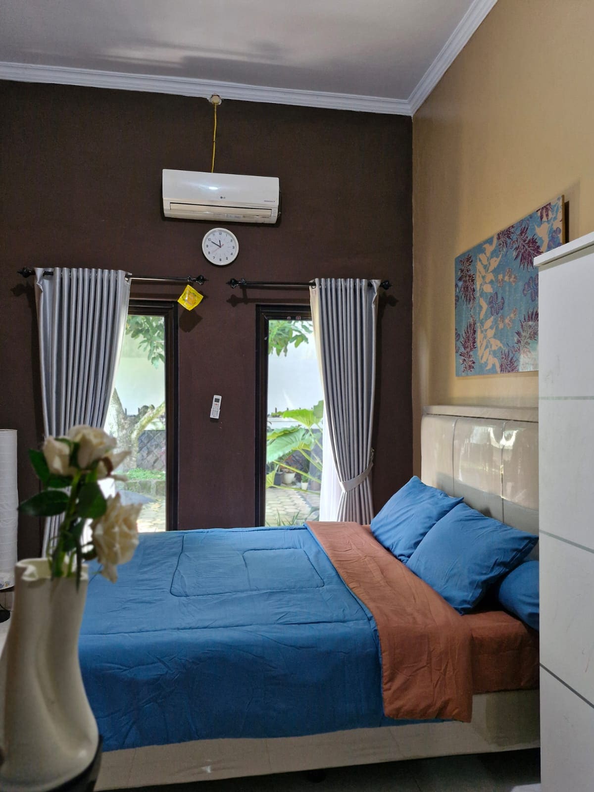 Habitación principal con cama tamaño queen, aire acondicionado  y baño en el interior 