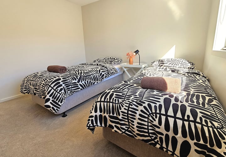 Bedroom 2 - a sizeable bedroom on the first floor with mountain views in the horizon. 2 single size bed with wardrobes. Alternative bed configuration can be arrange-queen bed - see other photo. Towels and freshly laundred linen are all provided. 