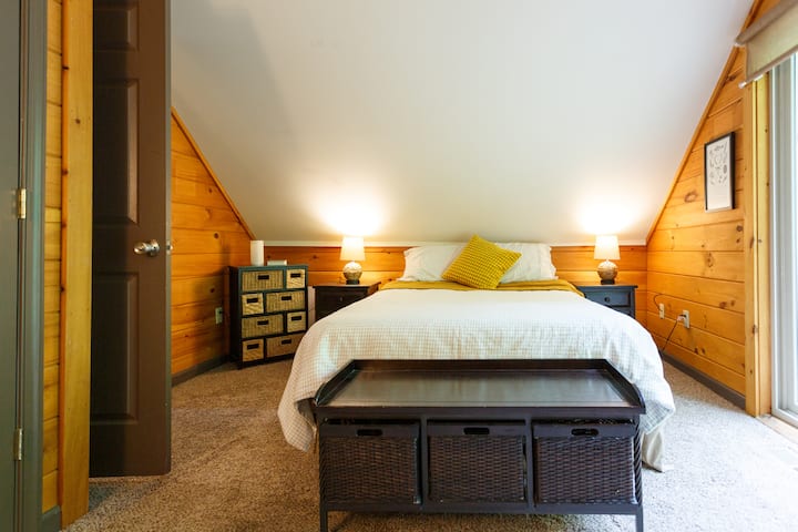 Bedroom #2 with queen bed and balcony overlooking patio deck & creek