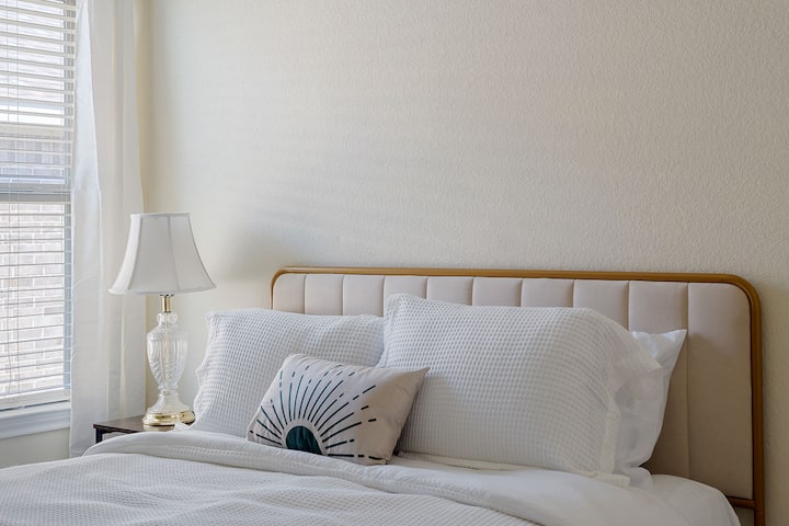 สำรวจห้องนอนที่สวยงามซึ่งมีโคมไฟข้างเตียงที่เพิ่มบรรยากาศที่น่ารื่นรมย์