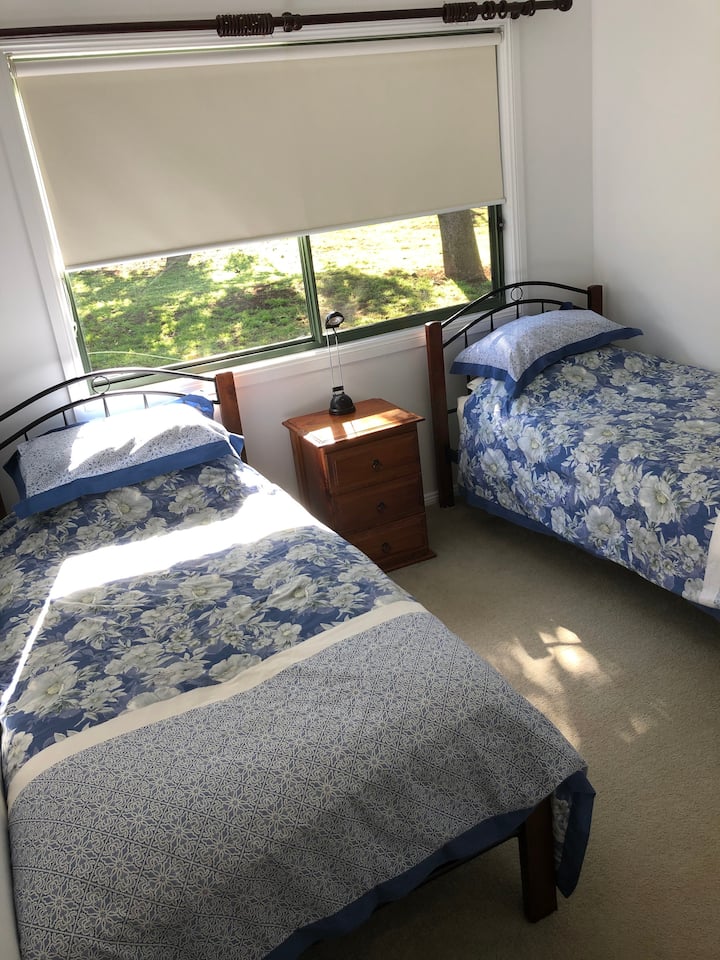 Second bedroom with 2 singles and wardrobe.