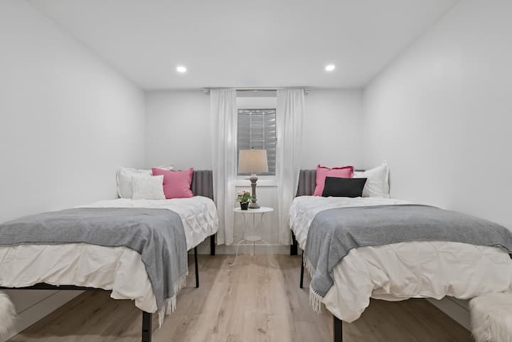 The basement level includes this two twin bedroom, comfortably sleeping two people, with an egress window for added safety.