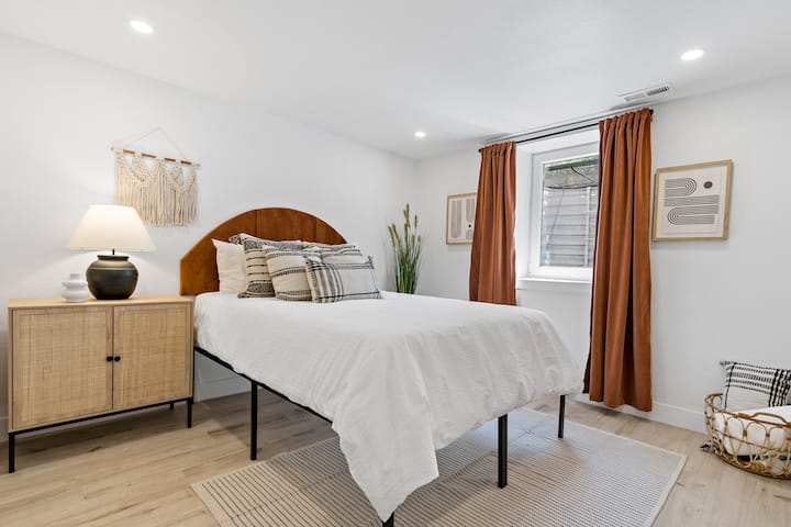 Our Terracotta bedroom features a queen-size bed that comfortably sleeps two people. The room also includes an egress window for basement-level safety.