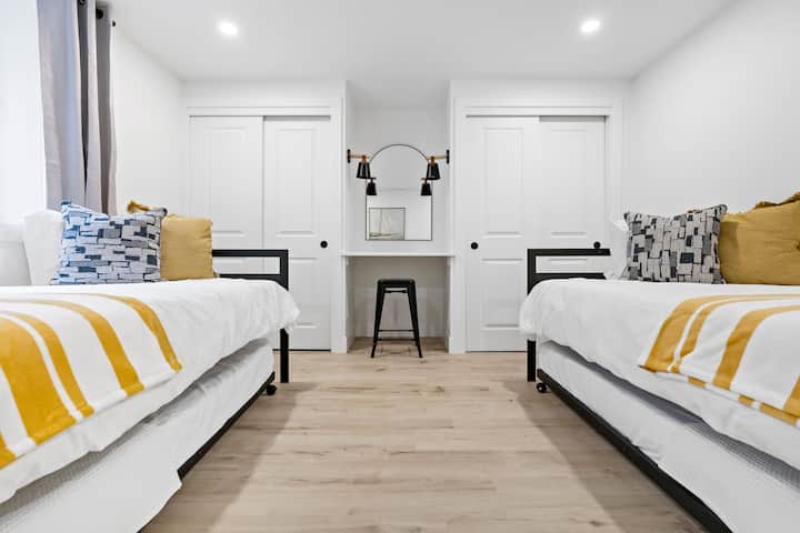 Two twin beds, each with a slide-out trundle, accommodating up to four people. The room also includes an egress window for basement-level safety.