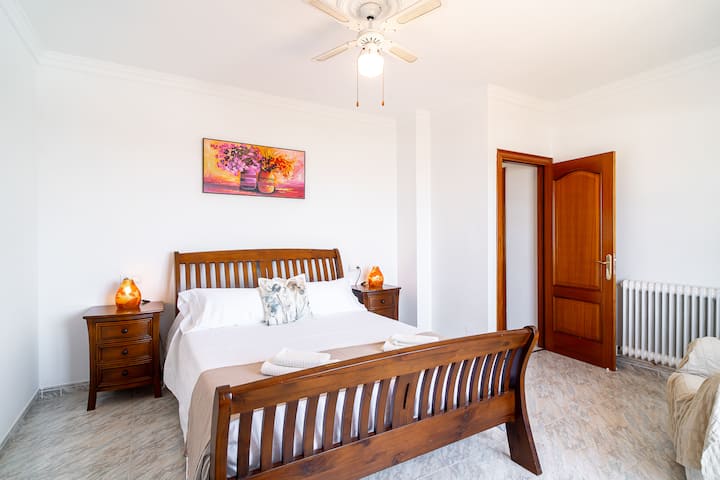 Dormitorio con cama de matrimonio y radiador.