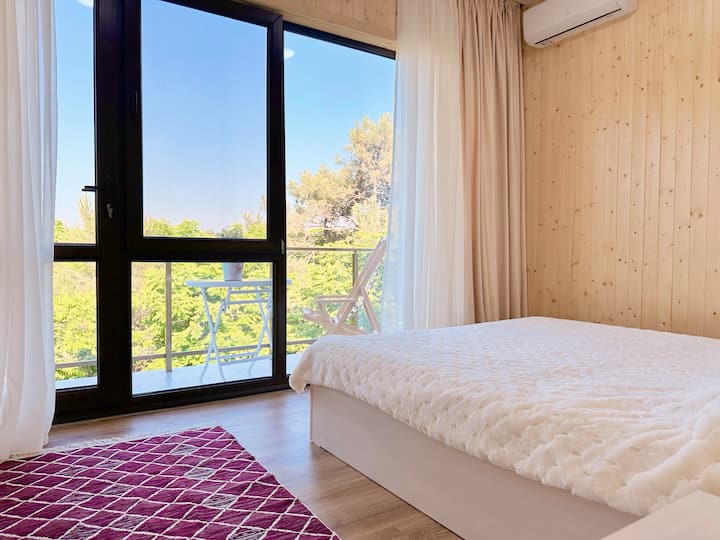 Bedroom #4 on the 2nd floor with a panoramic forest view and a balcony 