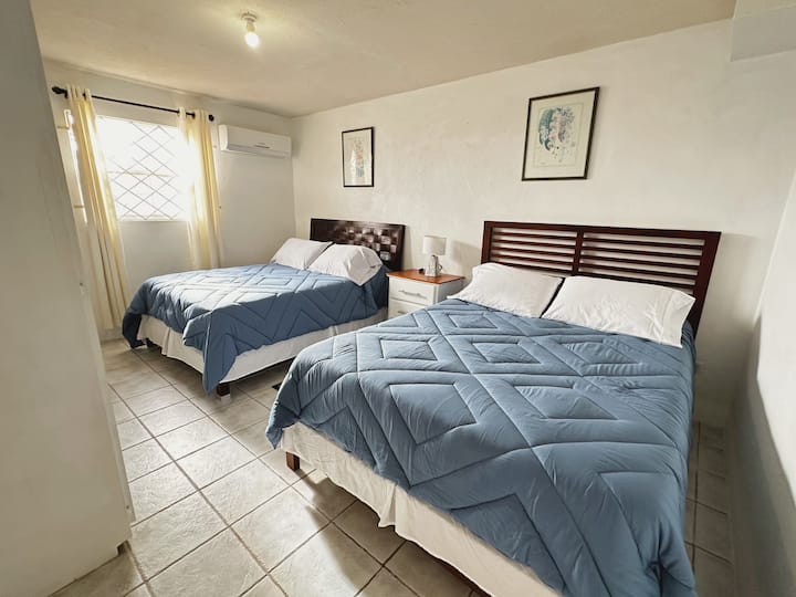 Two double beds, AC, beach towels, closets, storage, private bathroom