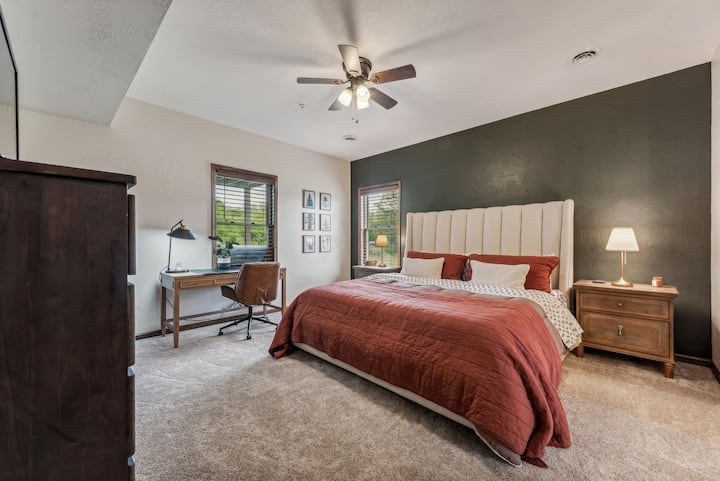 Master suite with a king bed and desk area for those looking to work remotely.