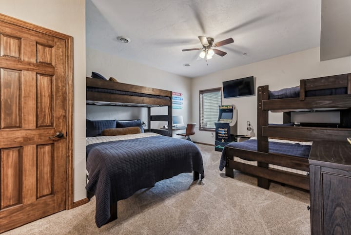 Bunk room is great for the kids. This bedroom features 2-  twin over full bunk beds, desk space, and an arcade golf game.