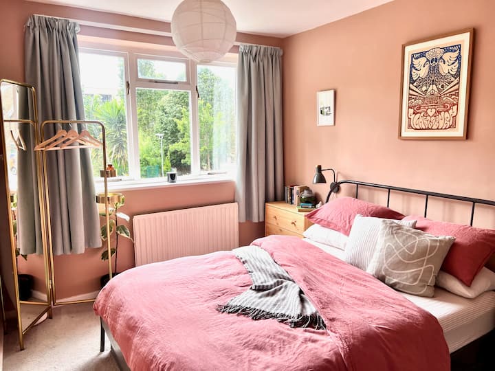 Dormitorio luminoso orientado al sur con vistas al jardín y al parque. 
Cómodo colchón tamaño king (Casper) con sábanas de lino y edredón de plumas. Elige entre almohadas de plumas o sintéticas para tu comodidad. 
Espacio para colgar y cajones. Wifi + altavoz Sonos.
